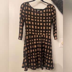 Black dress wirh brown square figures mini in size medium